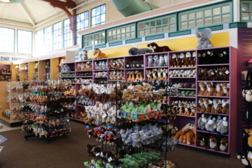 Gift Shop wall full of merchandise including animal plush toys and other souvenirs.