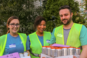 Brew at the Zoo volunteers holding cases of beer.