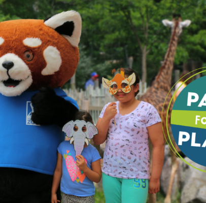 Three children posing with Roger Williams Park Zoo mascot in front of giraffe habitat. Image includes Party for the Planet logo.