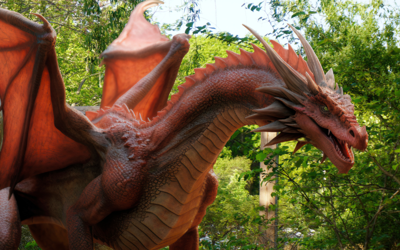 animatronic red dragon in the woods