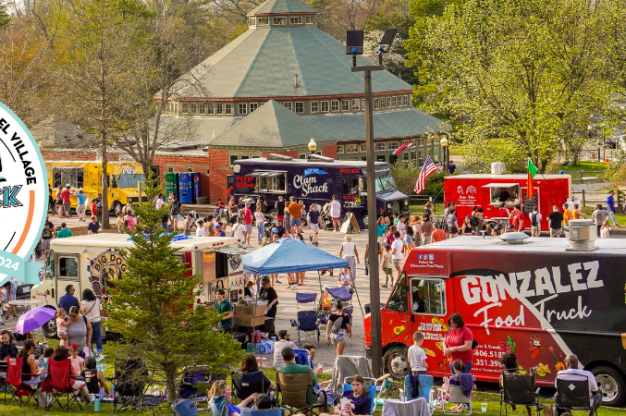 Food trucks and people outdoors at Carousel Village