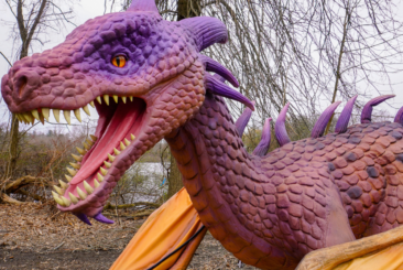 animatronic pink and purple dragon in the woods