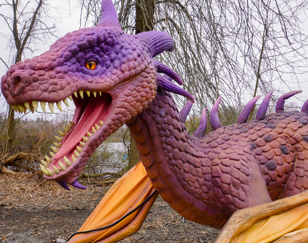 animatronic pink and purple dragon in the woods