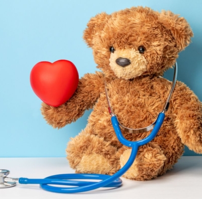 stuffed teddy bear holding a heart and a stethoscope